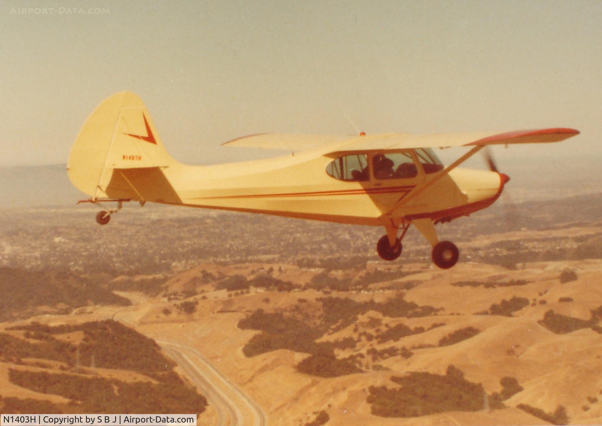 N1403H, 1950 Aeronca 15AC Sedan C/N 15AC-454, 03H flying near Sky Sailing airport around 1983. SF Bay Area. Notice the tow hook above tailwheel. Dan used 03H to tow banners.Did it for many years around the S F Bay Area.
