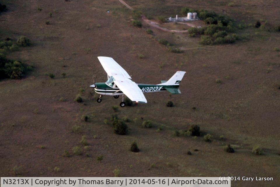 N3213X, 1966 Cessna 150G C/N 15064613, Our son Tyler Barry and his instructor in a air to air picture. 
They are flying in the Meacham Airport area.