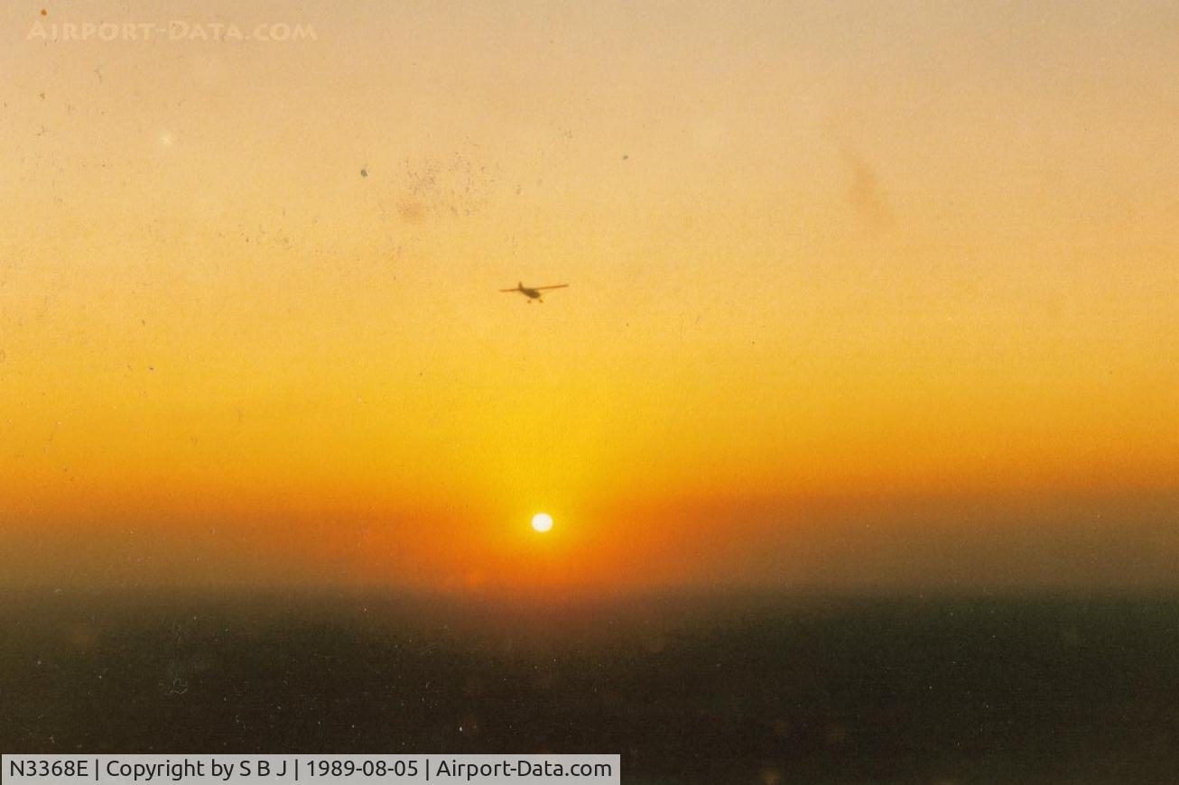 N3368E, 1947 Aeronca 11BC Chief C/N 11BC-1704, 68E flying toward the setting sun over Davenport,Iowa in 1989. We were trying to find the airport as 68E had no lights.