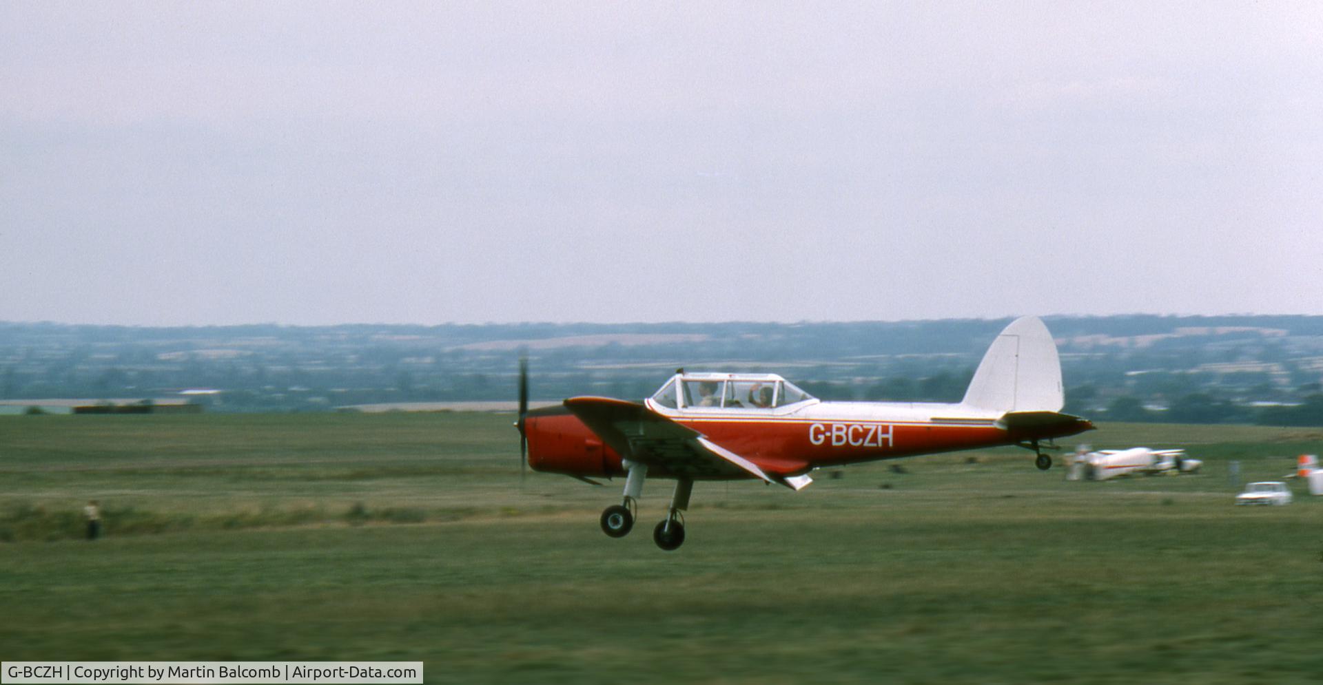 G-BCZH, 1952 De Havilland DHC-1 Chipmunk T.10 C/N C1/0635, Dunstable airfield, July 1975. The Chipmunk flies low over the field to drop its tow rope which it had been using to tow gliders from the London Gliding Club.
