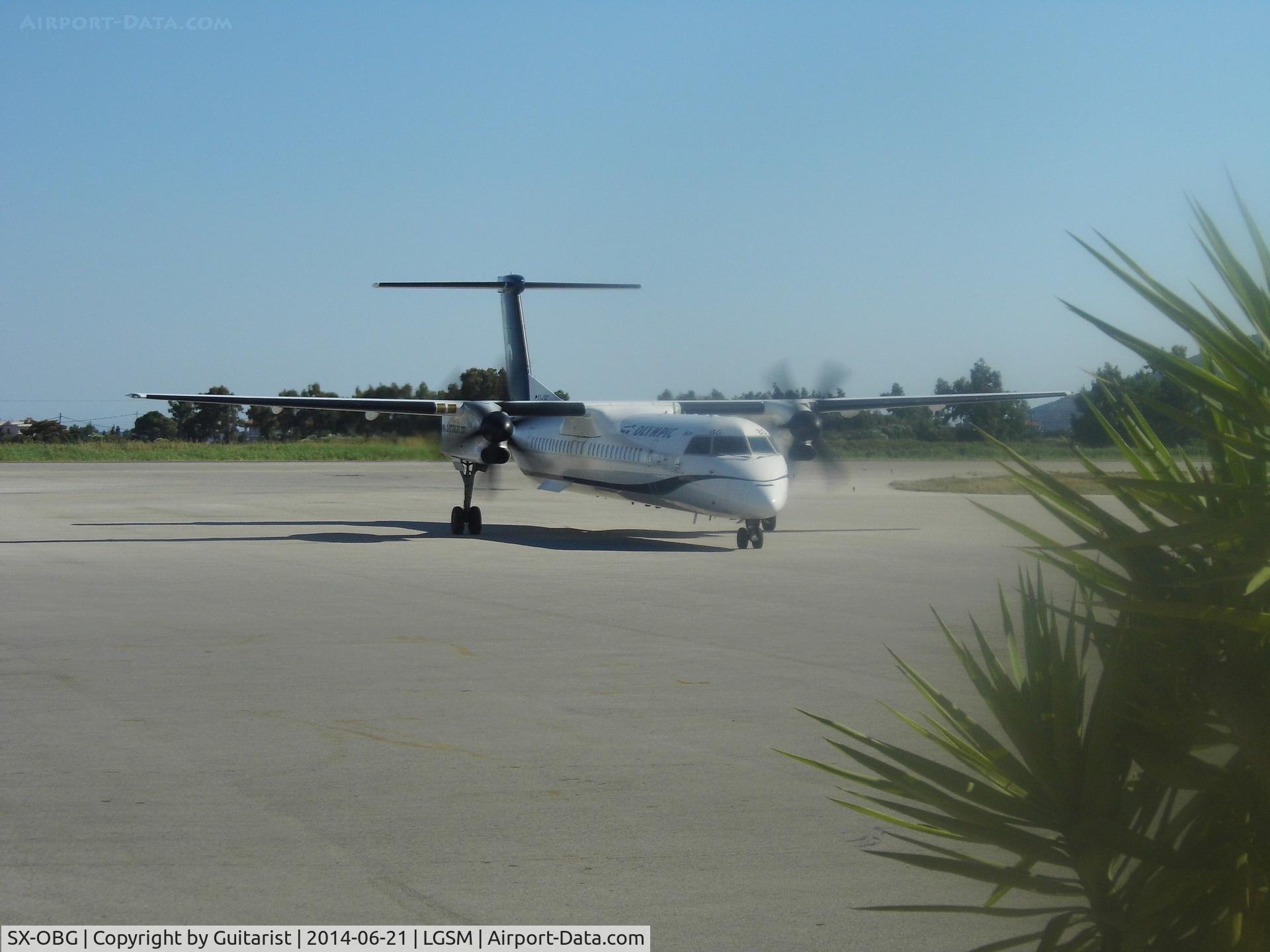 SX-OBG, 2010 De Havilland Canada DHC-8-402Q Dash 8 C/N 4321, Through the windows of gate 4 at Samos