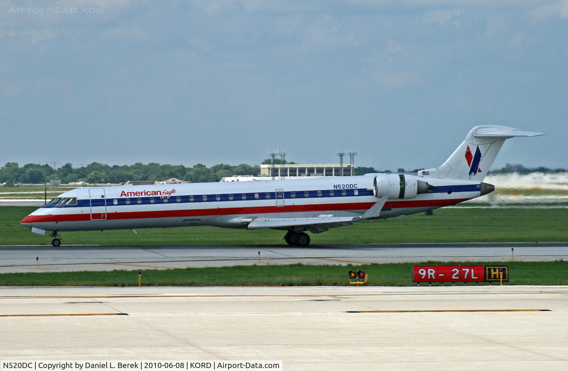 N520DC, 2004 Bombardier CRJ-701 (CL-600-2C10) Regional Jet C/N 10140, An American Eagle CRJ negotiates the labyrinth of taxyways at O'Hare.