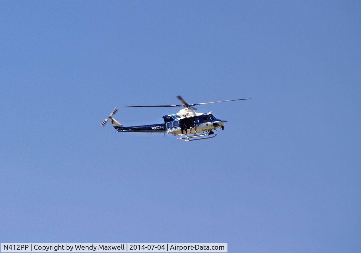 N412PP, 1990 Bell 412 C/N 33207, This was taken in Washington, DC on July 4, 2014. Those are police gunners on the helicopter which was circling around and hovering over the Lincoln Memorial and reflecting pool. This is a US Park Police helicopter assigned to the DC area.