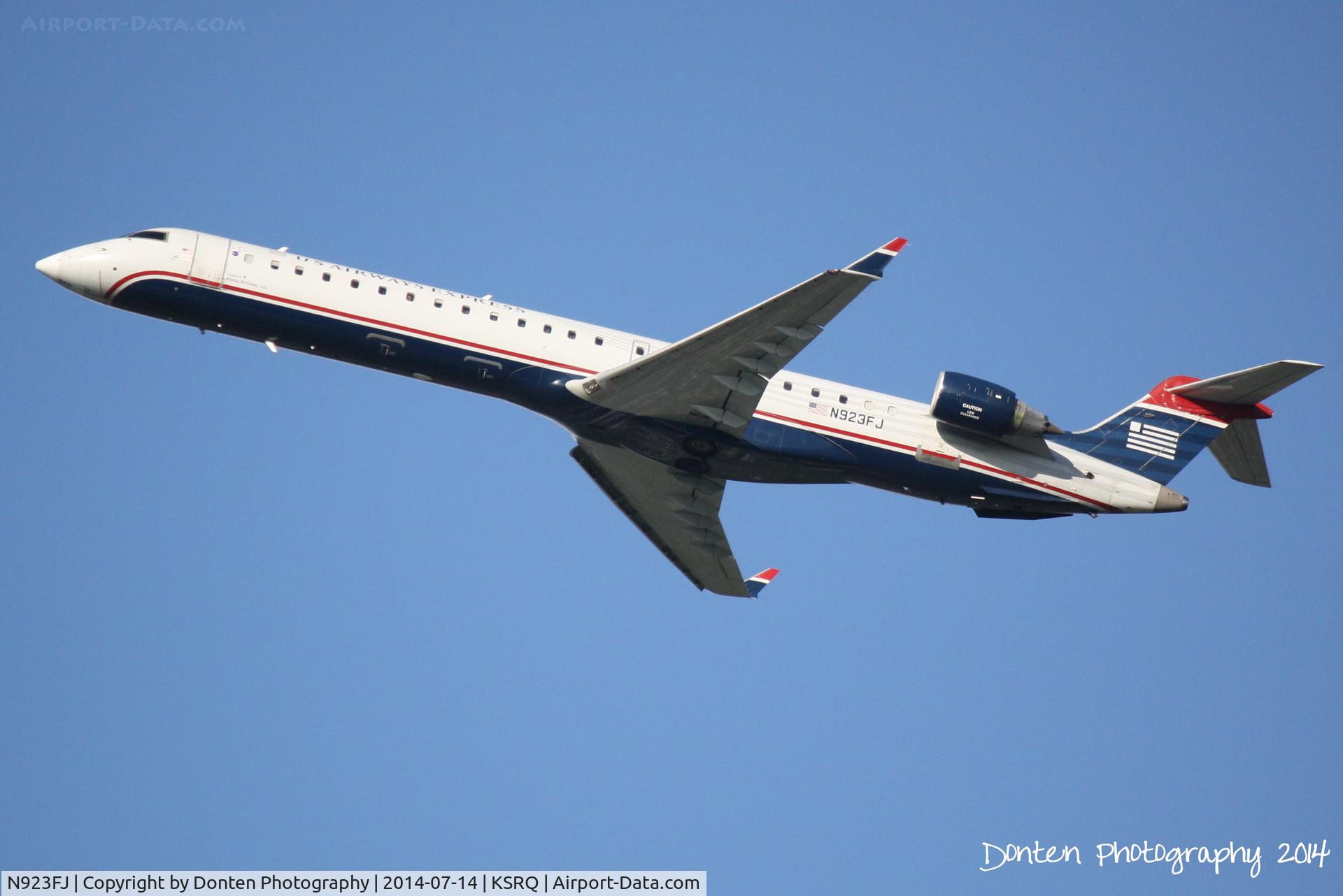 N923FJ, 2004 Bombardier CRJ-900ER (CL-600-2D24) C/N 15023, US Air Flight 2749 operated by Mesa (N923FJ) departs Sarasota-Bradenton International Airport enroute to Charlotte-Douglas International Airport