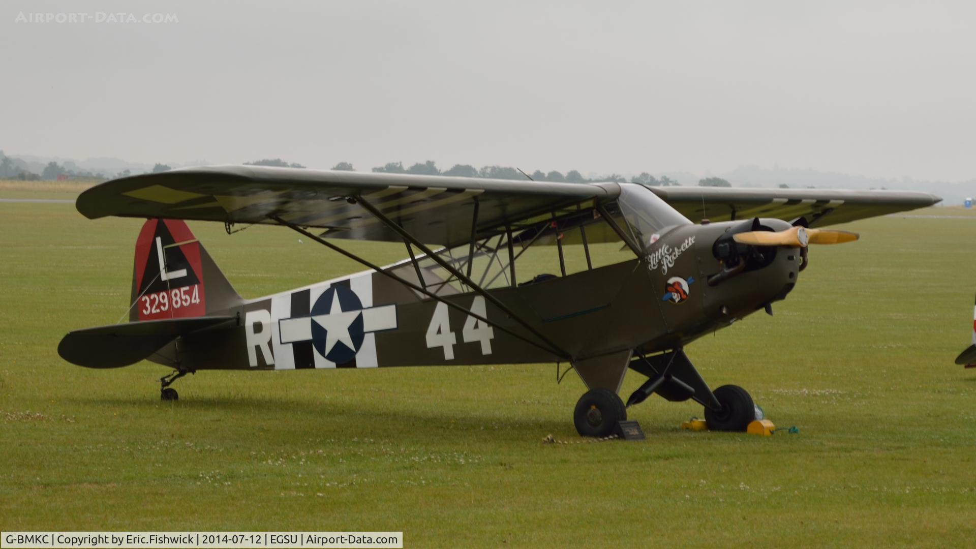 G-BMKC, 1943 Piper L-4H Grasshopper (J3C-65D) C/N 11145, 3. 329854 emerging from the morning mist at The Flying Legends Air Show, IWM Duxford. July,2014.