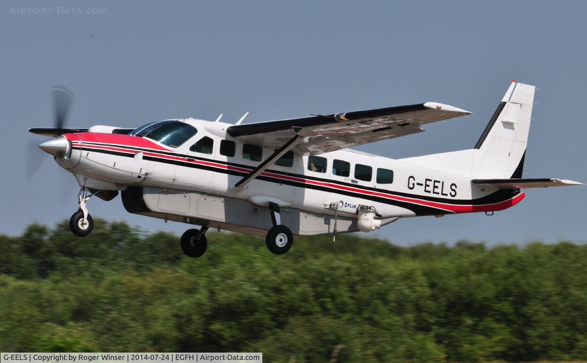 G-EELS, 1997 Cessna 208B Grand Caravan C/N 208B0619, Visiting Grand Caravan fitted with a TV camera departing Runway 22 to cover a golf tournament..