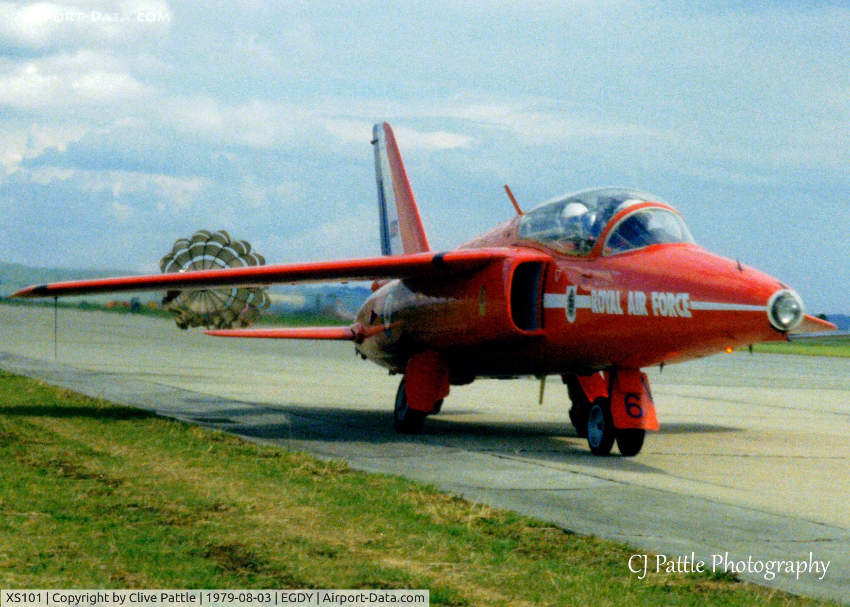 XS101, 1964 Hawker Siddeley Gnat T.1 C/N FL595, Scanned from a print. Taken at EGDY RNAS Yeovilton Air Day 3rd August 1979, Gnat T.1 XS101 caught landing with parachute deployed. Yes I was that close, standing centre airfield ready to launch the Commando Air Assault. Back seater looks worried !