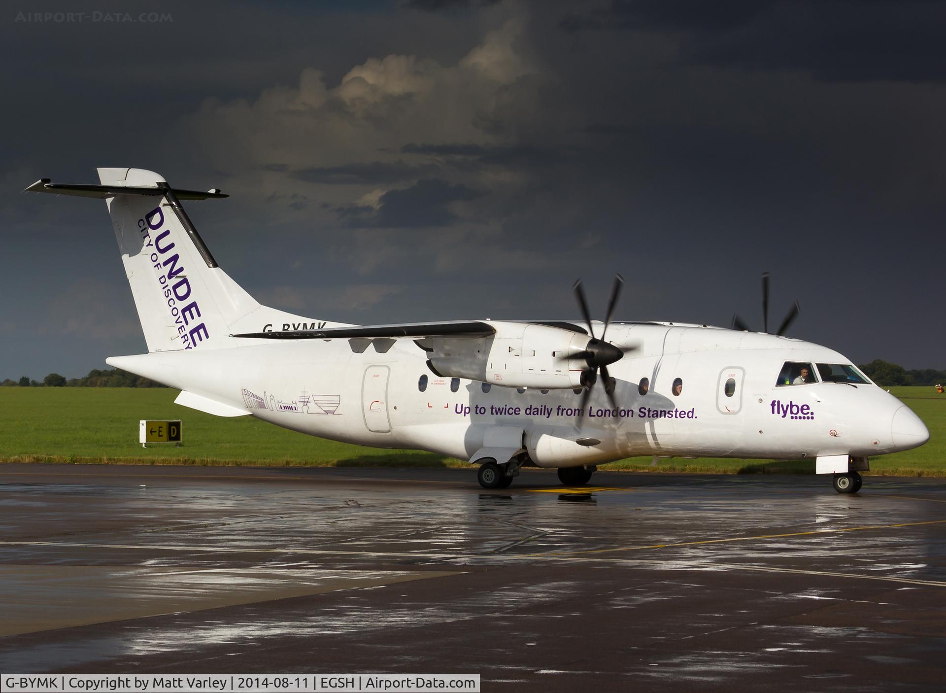 G-BYMK, 1996 Dornier 328-100 C/N 3062, Taxiing down delta moments after a thunderstorm....