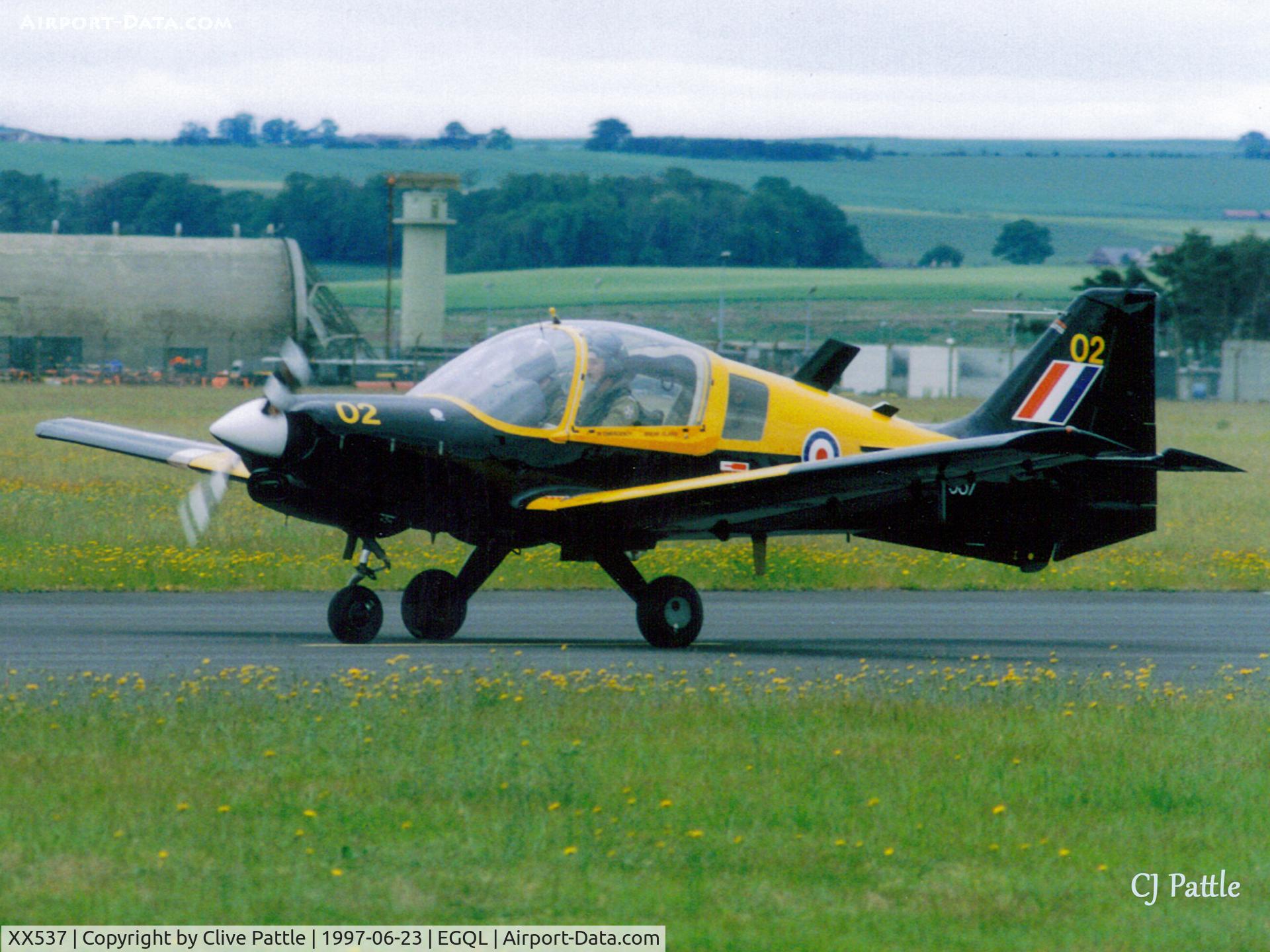 XX537, 1973 Scottish Aviation Bulldog T.1 C/N BH.120/223, Scanned from print. Bulldog T.1 coded '02' of Edinburgh , Dundee and St Andrews UAS taxies out for departure from Rwy 27 at RAF Leuchars