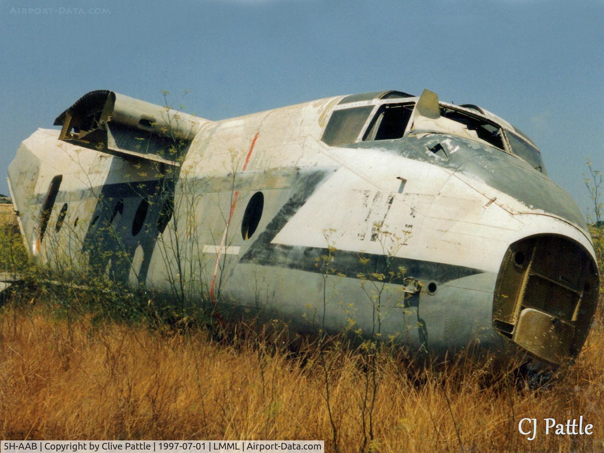 5H-AAB, De Havilland Canada DHC-4A Caribou C/N 244, Scanned from print. Remains of Caribou 5H-AAB at the International Fire Training Centre at Hal Far, Malta in July 1994. ICAO code LMML (Luqa) used for reference searching purposes only