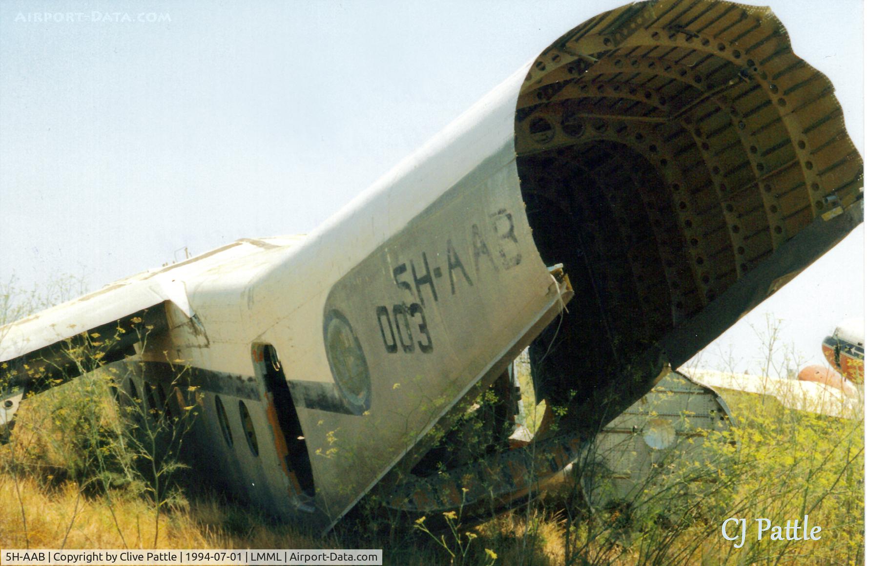 5H-AAB, De Havilland Canada DHC-4A Caribou C/N 244, Scanned from print - another view of DHC-4 Caribou 5H-AAB at the International Fire Training Centre at Hal Far (disused), Malta. ICAO LMML used for ref/search purposes.