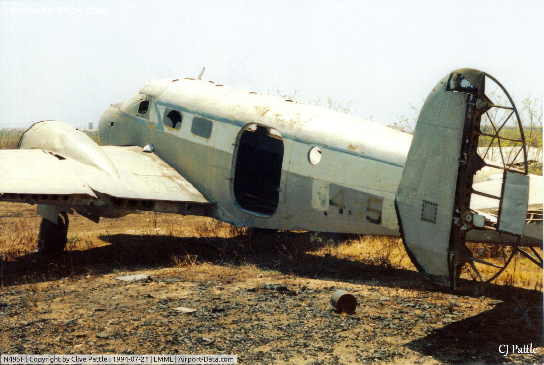 N495F, Beech D18S C/N AF-888, Scanned from print - another view of Beech 18 N495F at the International Fire Training Centre at Hal Far (disused), Malta in July 1994. ICAO code LMML used for reference/search purposes only.