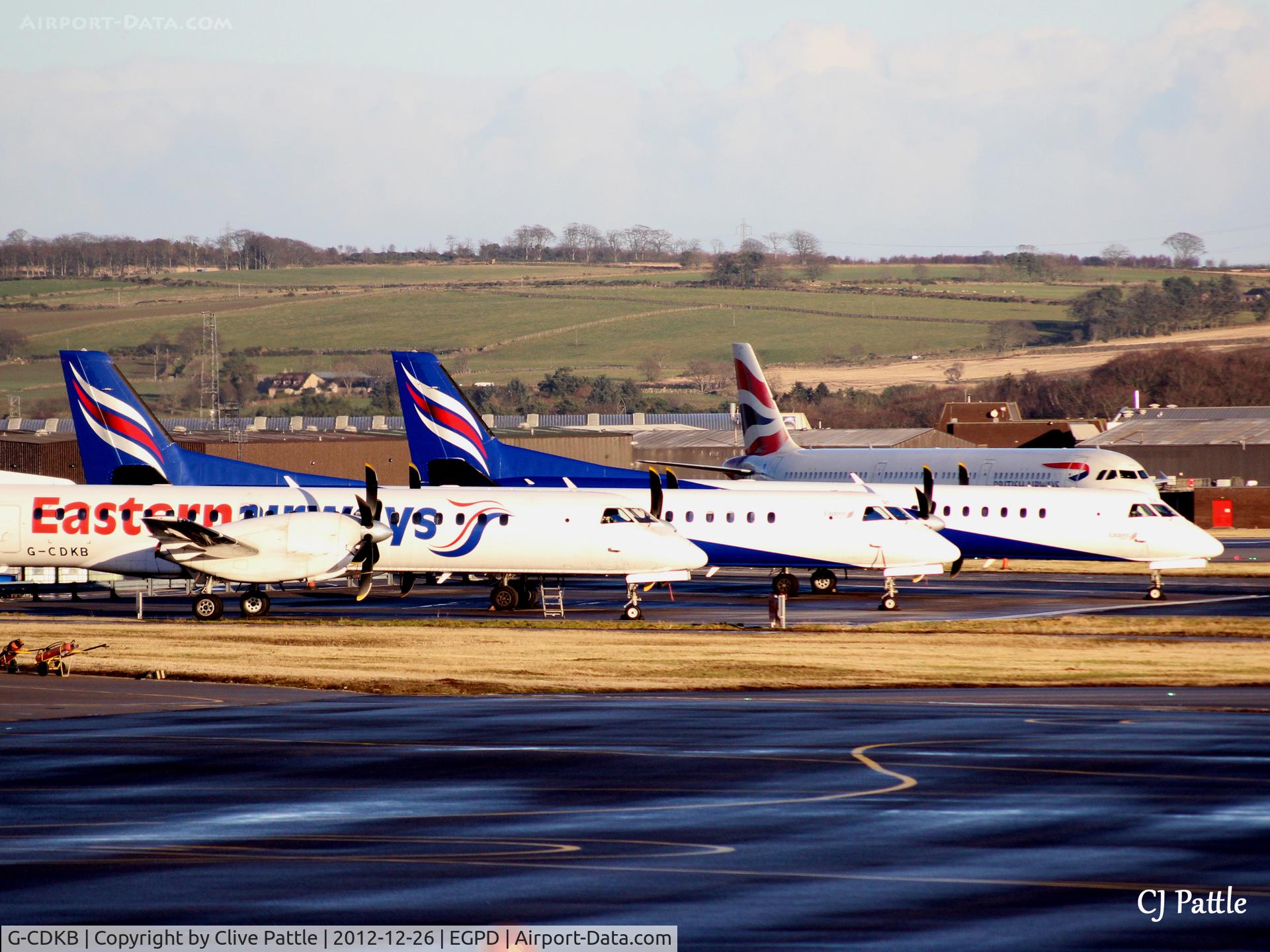 G-CDKB, 1996 Saab 2000 C/N 2000-032, 'KB, on left of line-up at Aberdeen EGPD Boxing Day sunset