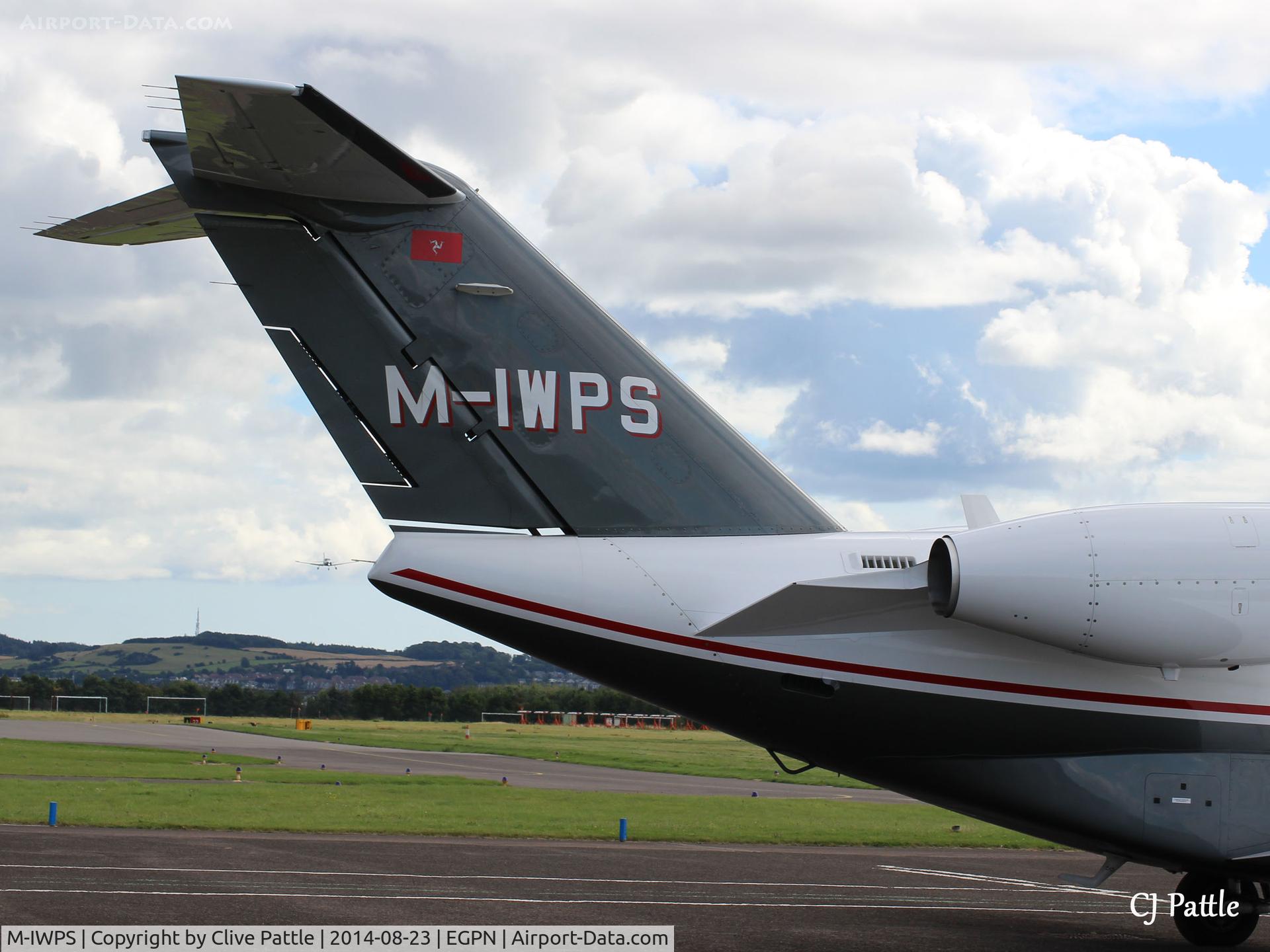 M-IWPS, 2012 Cessna 525A CitationJet CJ2+ C/N 525A-0496, Close-up of tail unit of M-IWPS (aircraft was parked very close to a fence that prevented a shot of the complete aircraft) parked up at Dundee Riverside. Note a based Cherokee of Tayside Aviation landing in the background.
