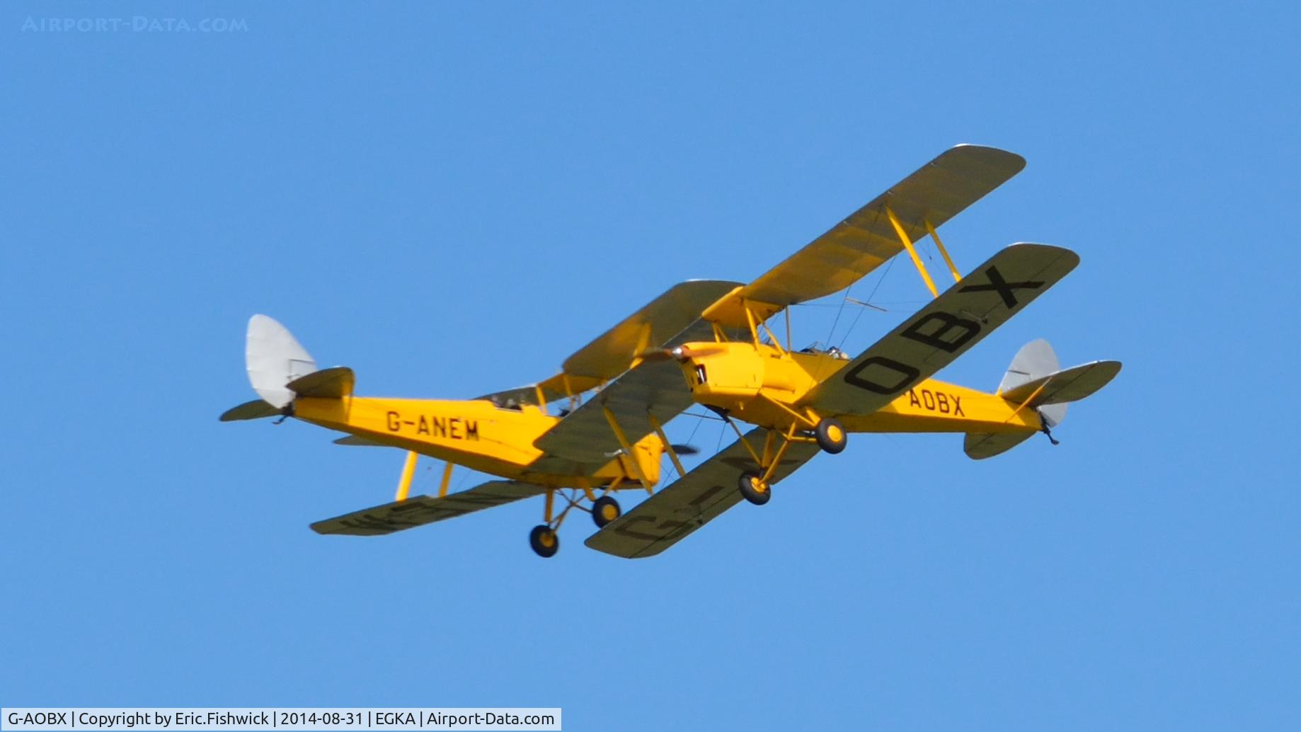 G-AOBX, 1940 De Havilland DH-82A Tiger Moth II C/N 83653, 45. G-AOBX and reflection (G-ANEM) at the superb 25th Anniversary RAFA Shoreham Airshow, Aug. 2014