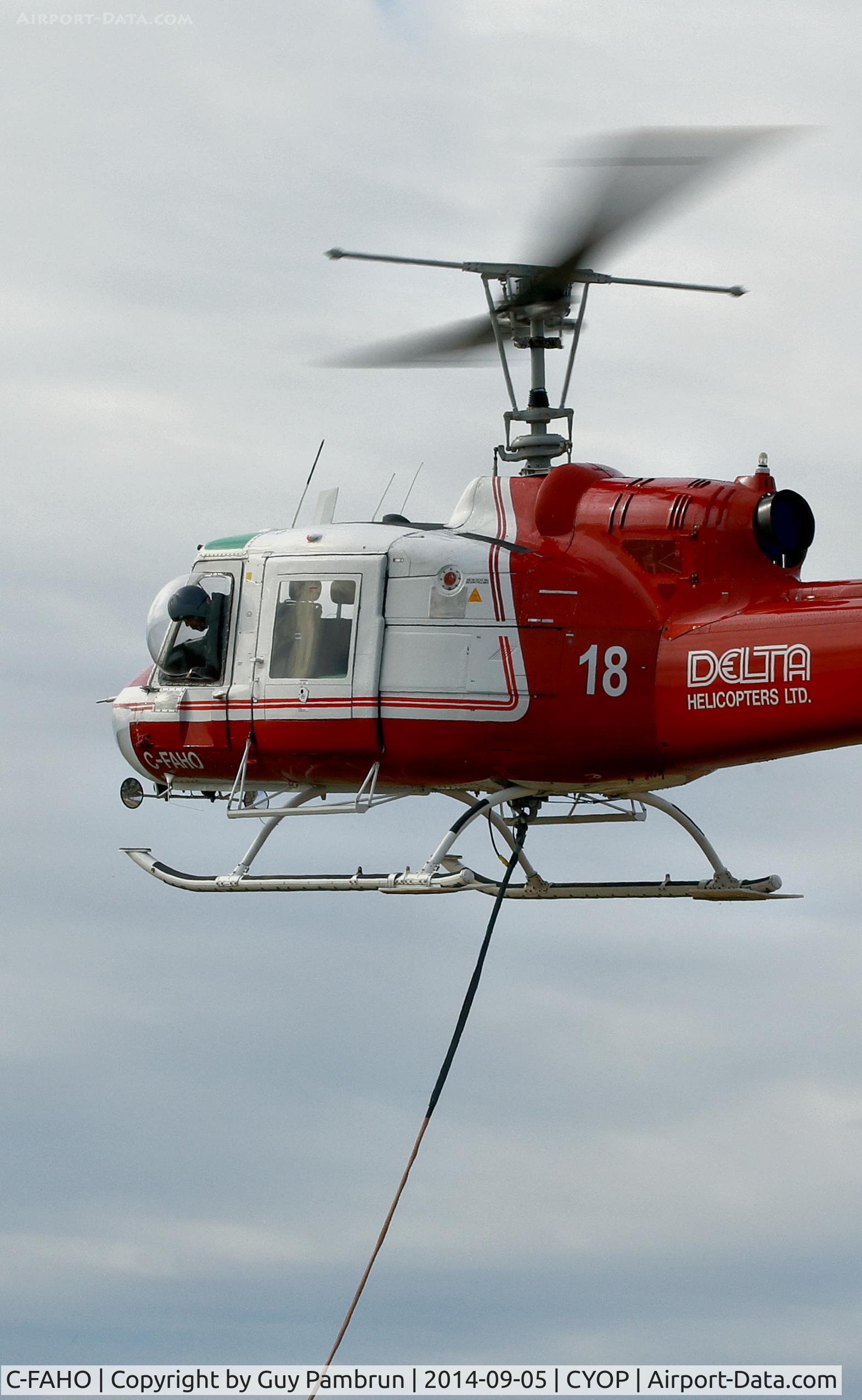 C-FAHO, 1967 Bell 204B C/N 2060, Picking up a load and heading to the bush.