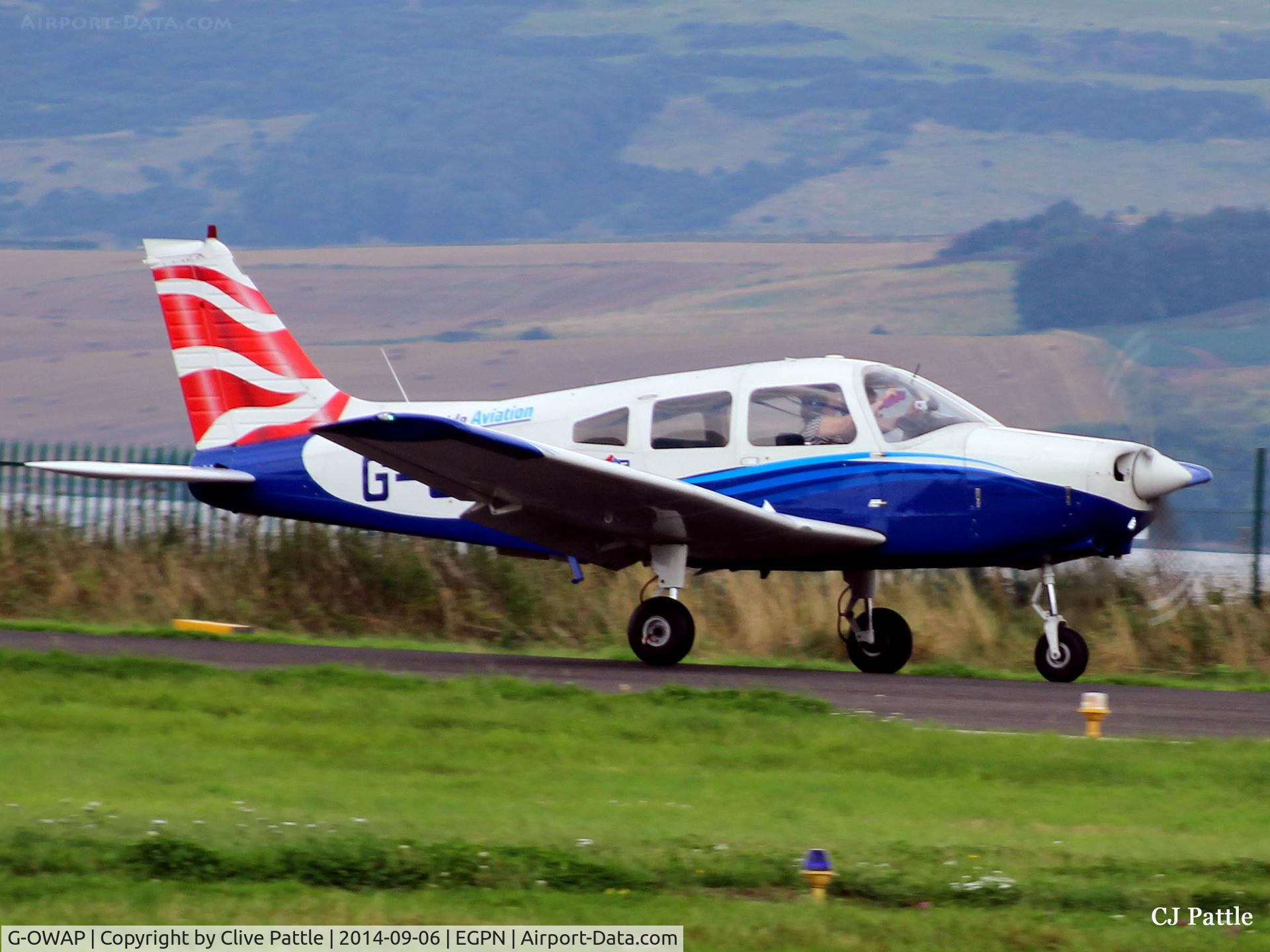 G-OWAP, 1977 Piper PA-28-161 Cherokee Warrior II C/N 28-7816314, Landing at Dundee EGPN with front seat passenger taking photos