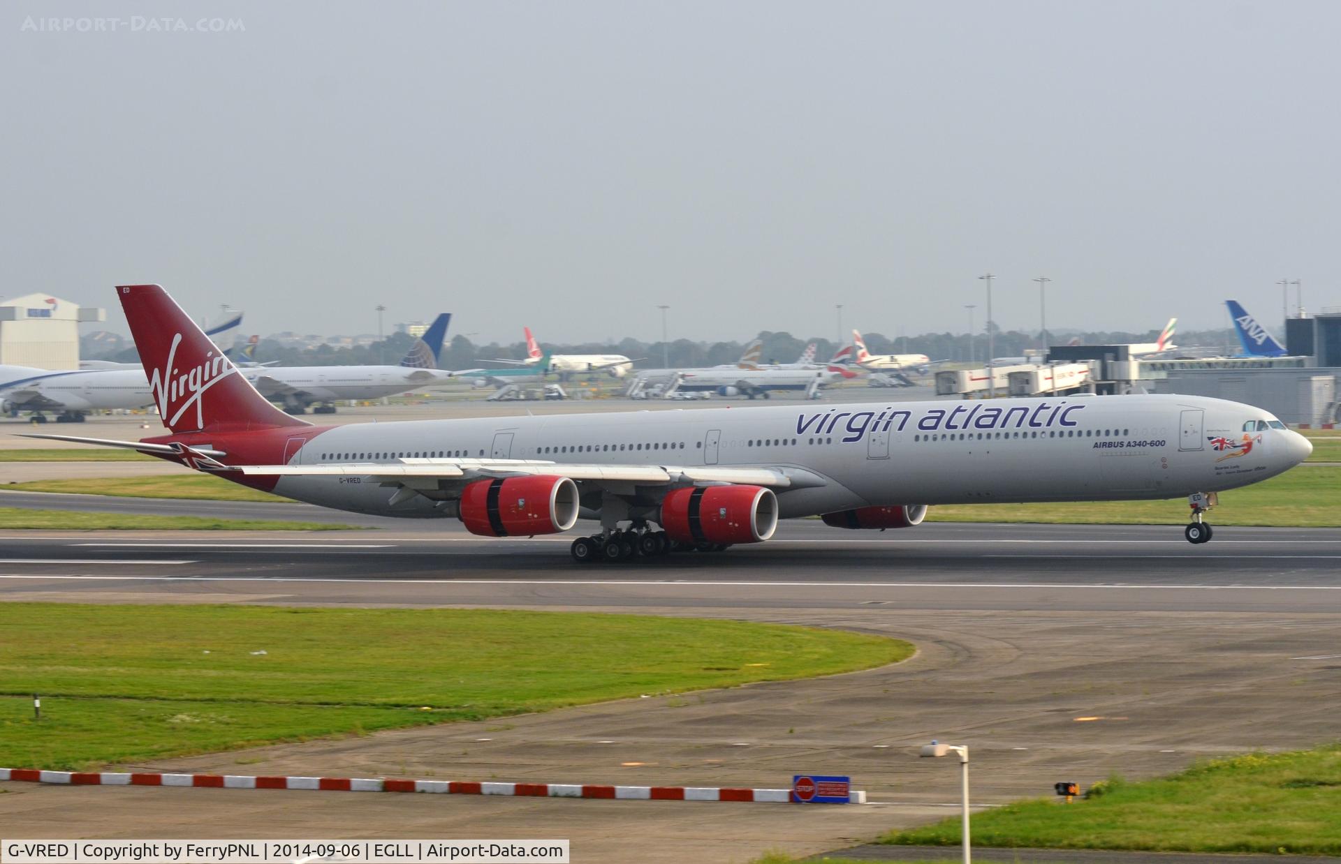 G-VRED, 2006 Airbus A340-642 C/N 768, Scarlet Lady laning at its base.