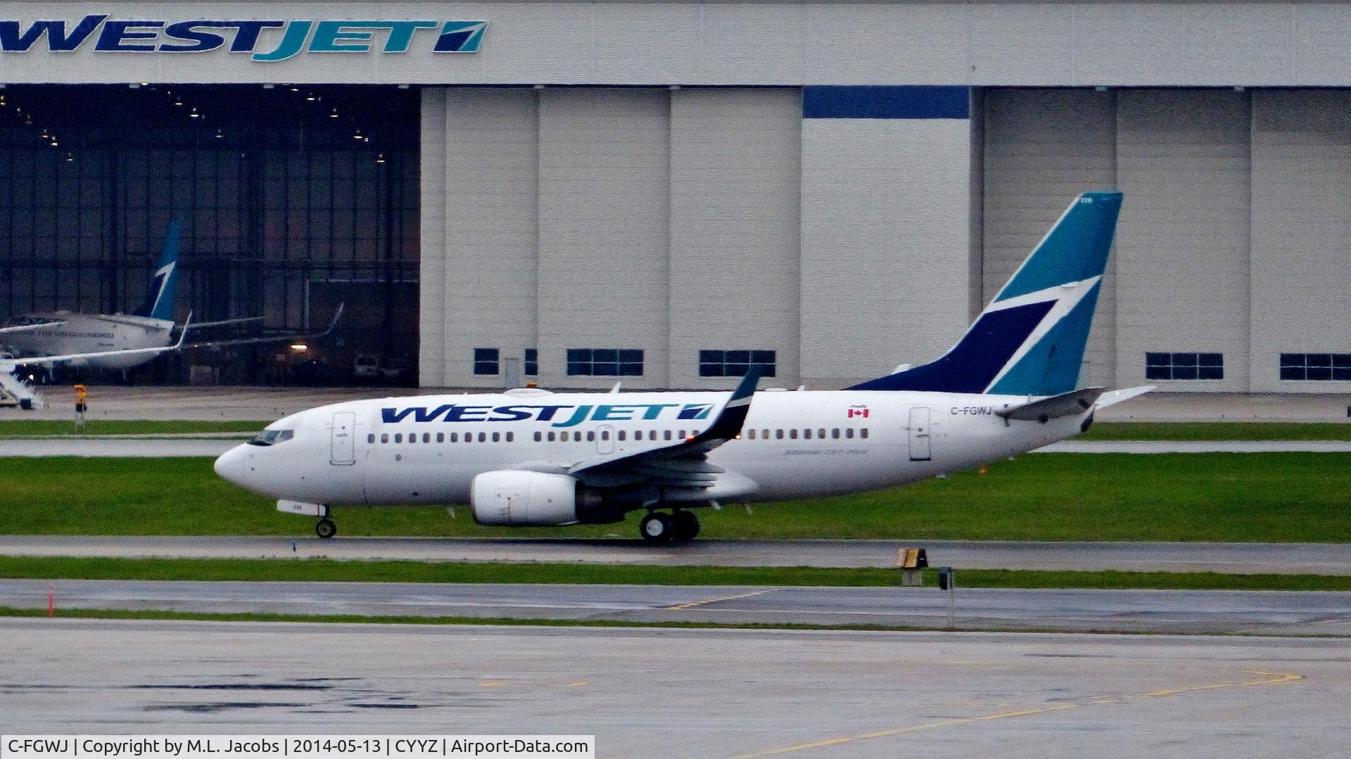 C-FGWJ, 2004 Boeing 737-7CT C/N 32764, WestJet Boeing 737 on a rainy morning.