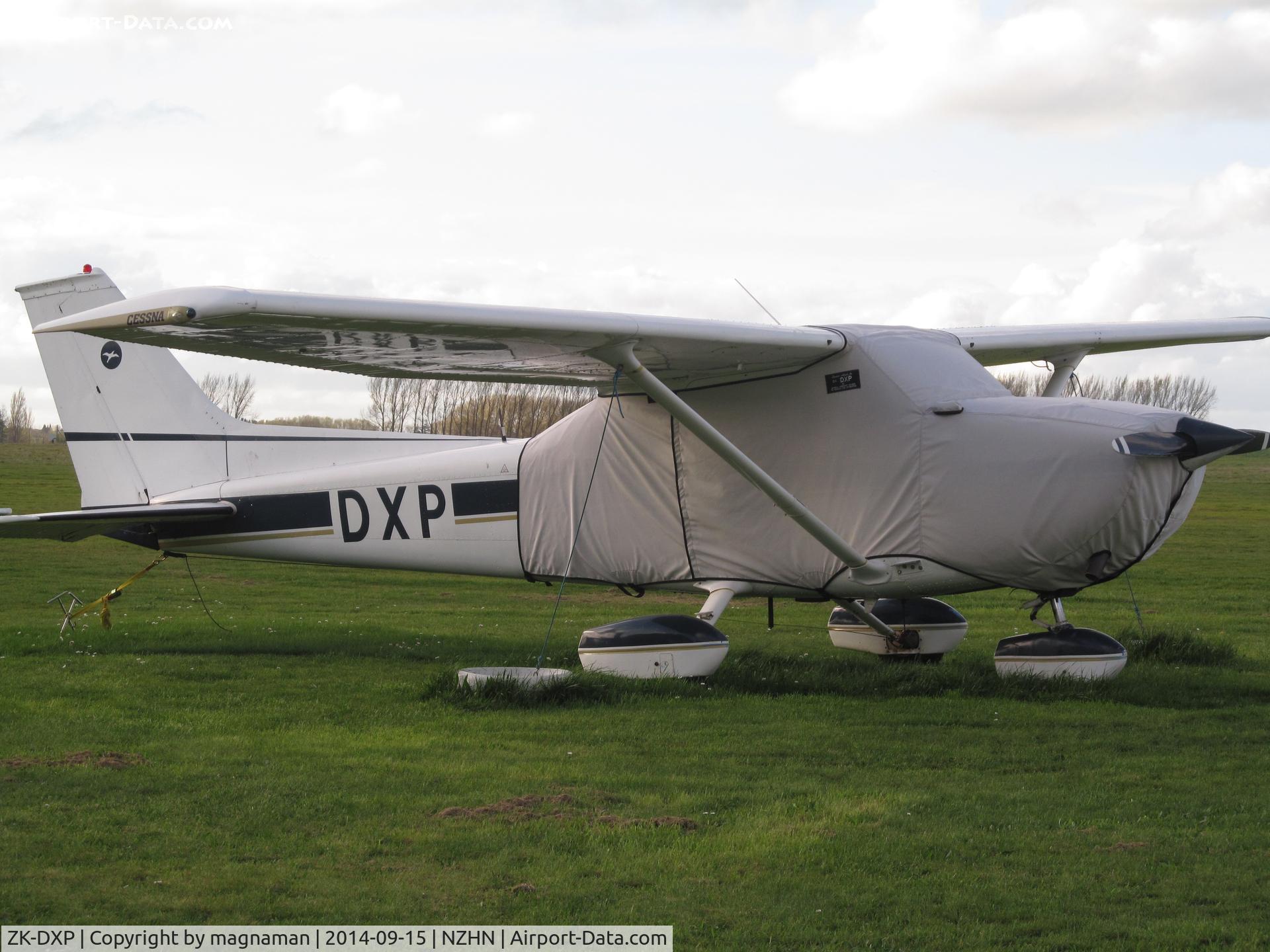 ZK-DXP, Cessna 172M C/N 17265333, Keeping warm at Hamilton - flying club grass area.