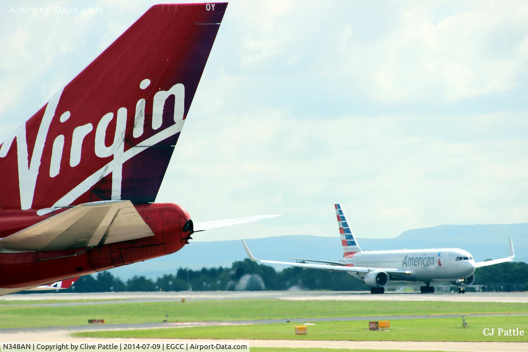 N348AN, 2003 Boeing 767-323/ER C/N 33087, Landing at Manchester airport EGCC behind Virgin Airlines B747 G-VROY