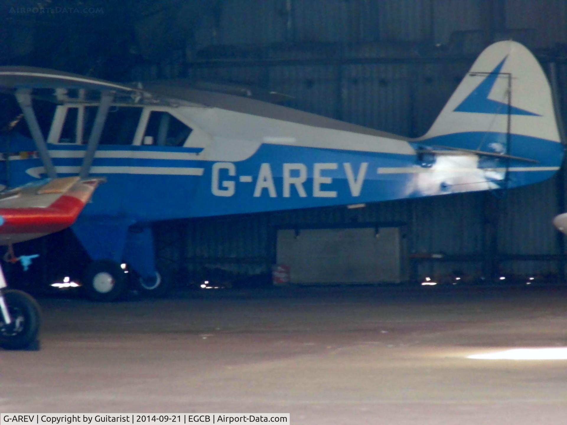 G-AREV, 1958 Piper PA-22-160 Tri Pacer C/N 22-6540, Up the corner of a hangar at the City Airport Manchester