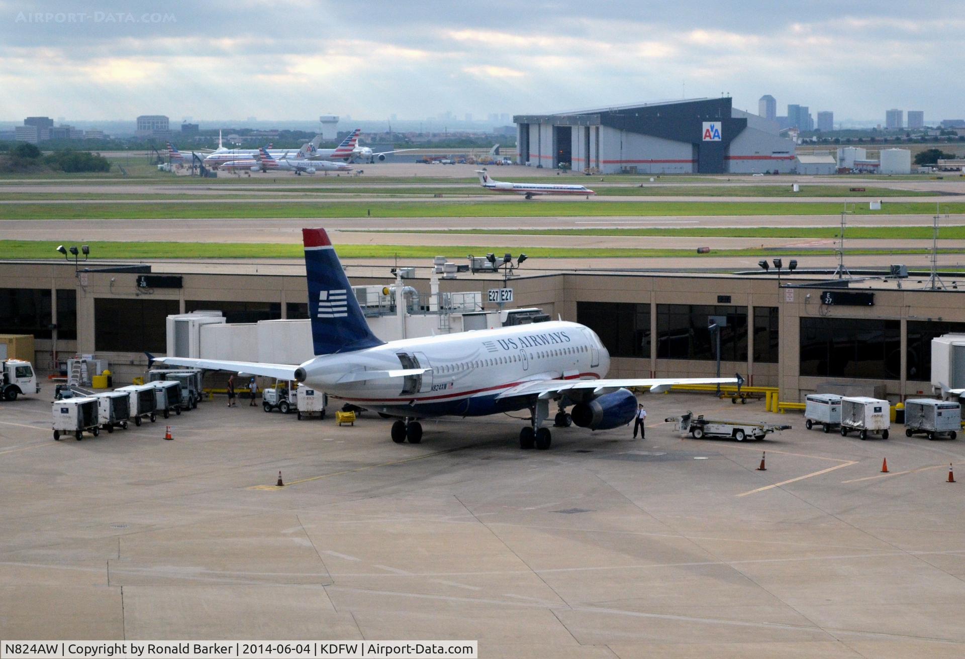 N824AW, 2001 Airbus A319-132 C/N 1490, Gate E27 DFW  First Officer preflighting engine number 2.