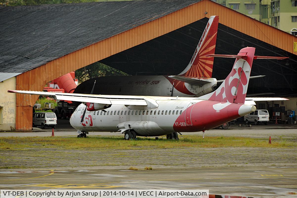 VT-DEB, 1995 ATR 72-202(F) C/N 456, A wet, grey afternoon at Calcutta reveals all sorts of stored equipment in the distance. Behind the ATR-72 is an Air India Cargo B-737, Indian Airlines ground equipment and a Kingfisher bus.