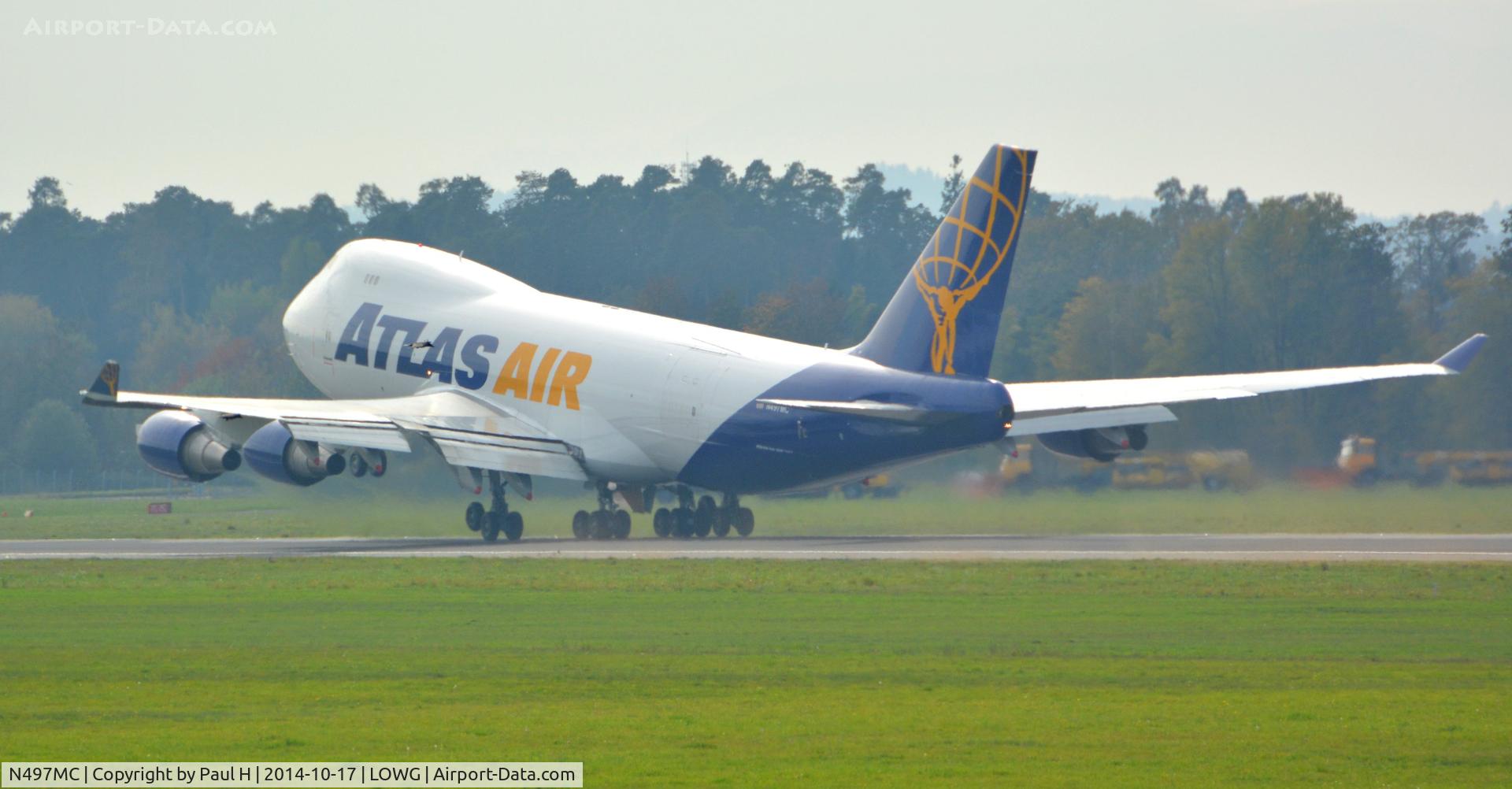 N497MC, 1999 Boeing 747-47UF C/N 29258, B744F having transported RedBull aircrafts to Graz taking-off to Hong Kong