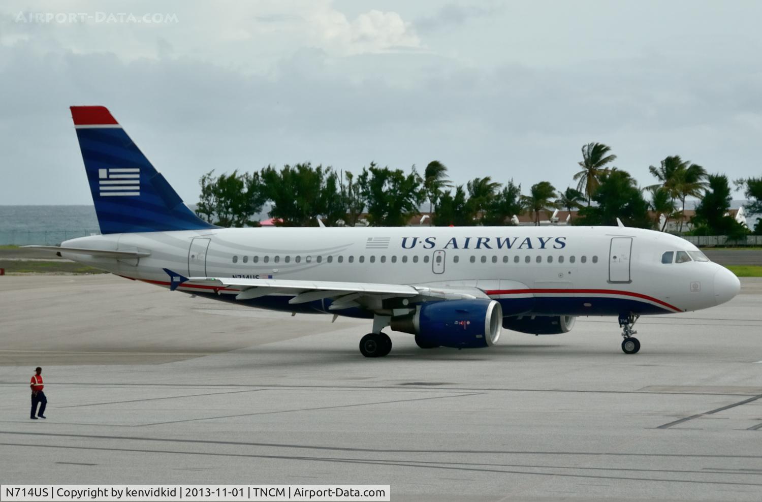 N714US, 1999 Airbus A319-112 C/N 1046, At the terminal awaiting our departure, which incidentally was delayed for 24 hours because of wind sheer and a torrential thunderstorm.