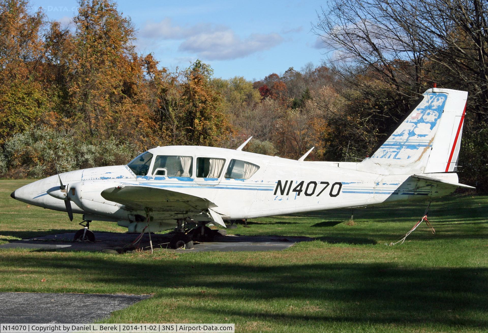 N14070, 1971 Piper PA-23-250 Aztec C/N 27-4677, This Piper Aztec has been sitting here for quite a while.  Her tires flattened and the runway at Newton Airport blocked by utility construction vehicles, there is no way out for this old bird.