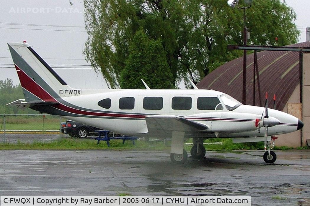 C-FWQX, 1967 Piper PA-31 C/N 31-92, Piper PA-31-310 Navajo [ 31-92] St. Hubert~C 17/06/2005. Taken from moving coach slight reflection from this  or rain water on the window.