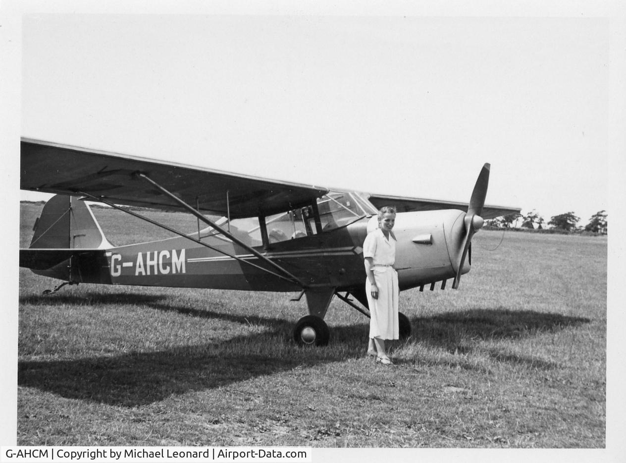 G-AHCM, 1946 Auster J-1N Alpha C/N 1979, This is my mother with the plane owned by a friend. It was taken in about 1949 in England.