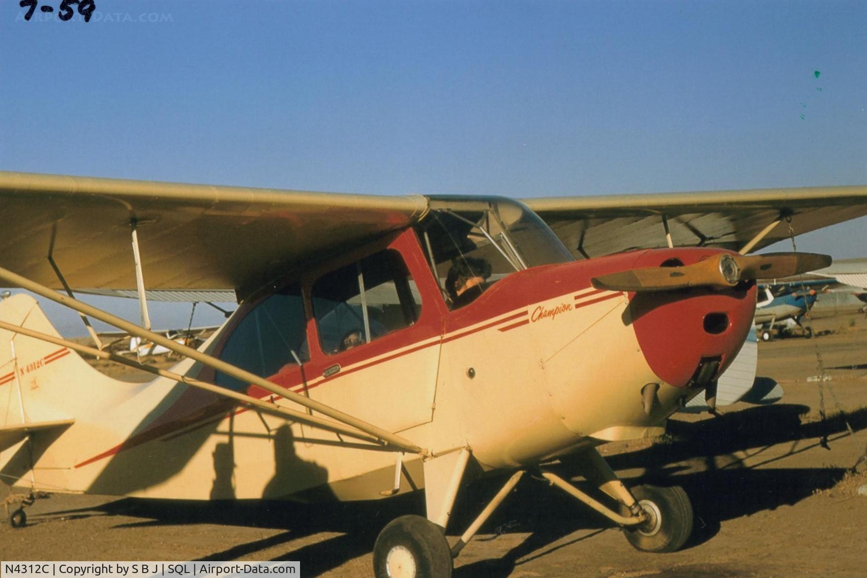N4312C, Champion 7EC C/N 7EC-313, 12C in its original factory colors which I felt looked good on the Champ.Unfortunately, 12C was destroyed in a low flying accident (8-24-74) near Chico,Calif. when some trees  got in its way. Picture is soon after purchase.