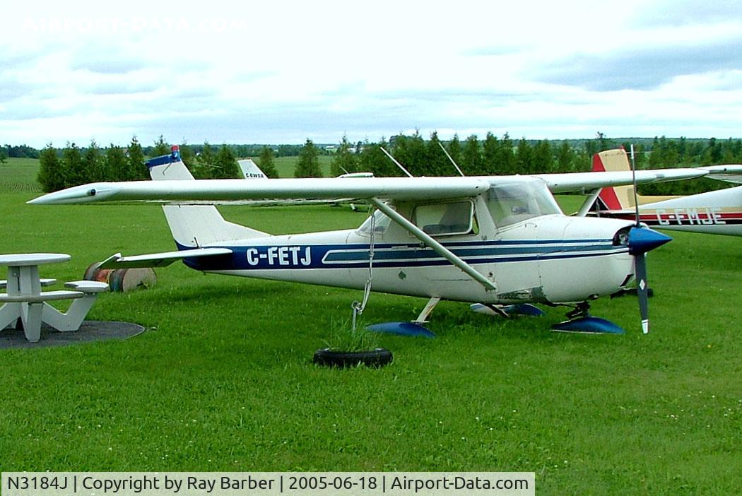 N3184J, Cessna 150G C/N 15065884, Cessna 150G [150-65884] Vankleek Hill~C 18/06/2005 Wears false marks of C-FETJ. Stored next to Herbs Truck Stop on Route 417 Ontario.
