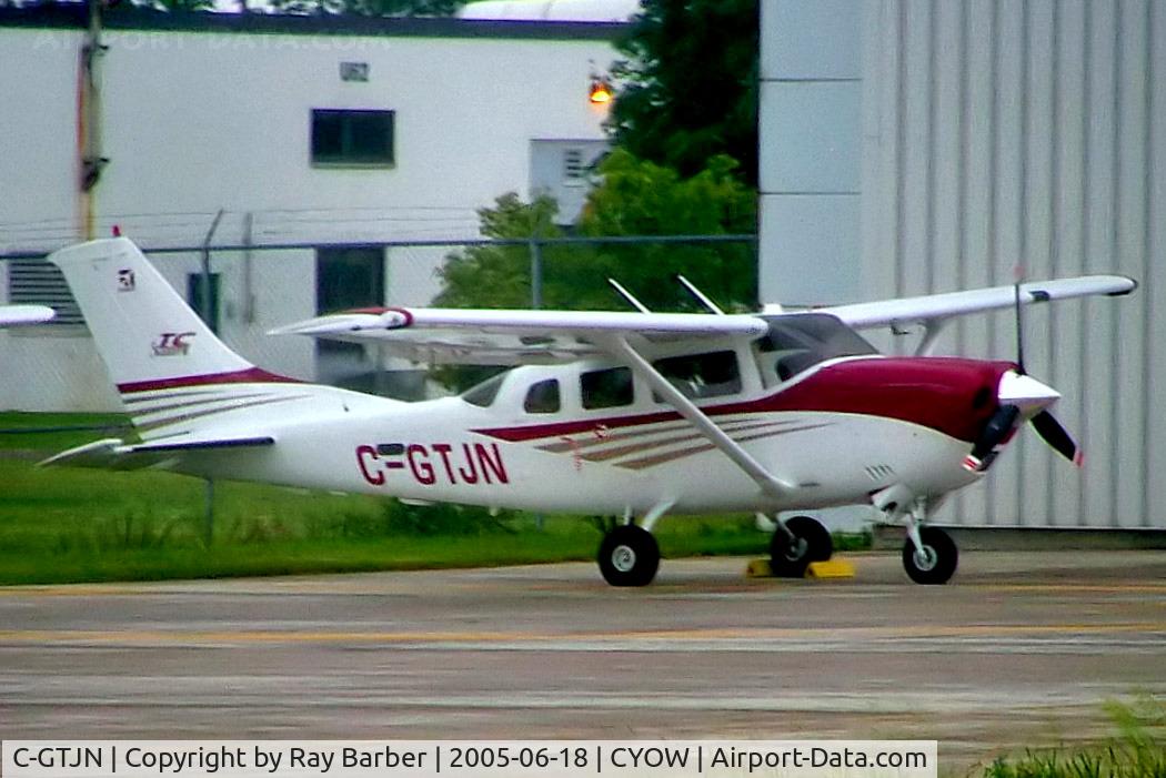 C-GTJN, 2004 Cessna T206H Turbo Stationair C/N T20608443, Cessna T.206H Turbo Stationair [T206-08443] Ottawa-Macdonald Cartier International~C 18/06/2005.Taken through glass on coach whilst moving.