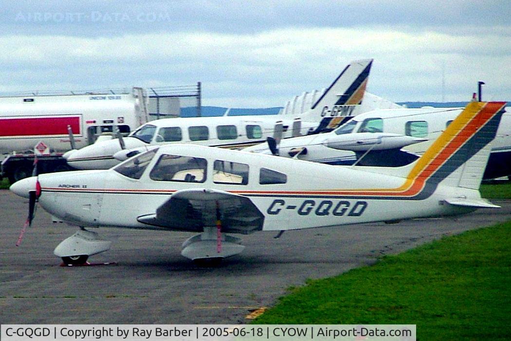 C-GQGD, 1977 Piper PA-28-181 Archer C/N 28-7790587, Piper PA-28-181 Archer II [28-7790587] Ottawa-Macdonald Cartier International~C 18/06/2005. Taken through glass on coach whilst moving.