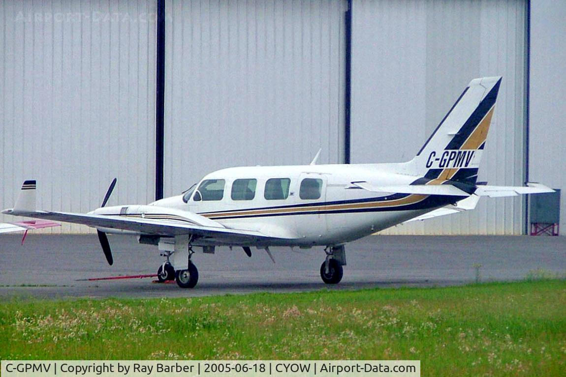 C-GPMV, 1977 Piper PA-31 C/N 31-7712081, Piper PA-31-325 Navaji C/R [31-7712081] Ottawa-Macdonald Cartier International~C 18/06/2005. Taken through glass on coach whilst moving.