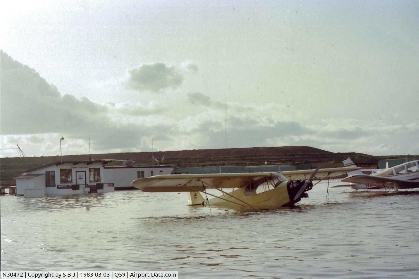 N30472, 1940 Piper J3L-65 Cub C/N 4859, One of the many floods at the Fremont airport in Calif. Water receded quickly and was not SF Bay water. 472 was a rental which I flew for an hour or two. That small building was the flight school.Many great flights were made inside it both real & imagined