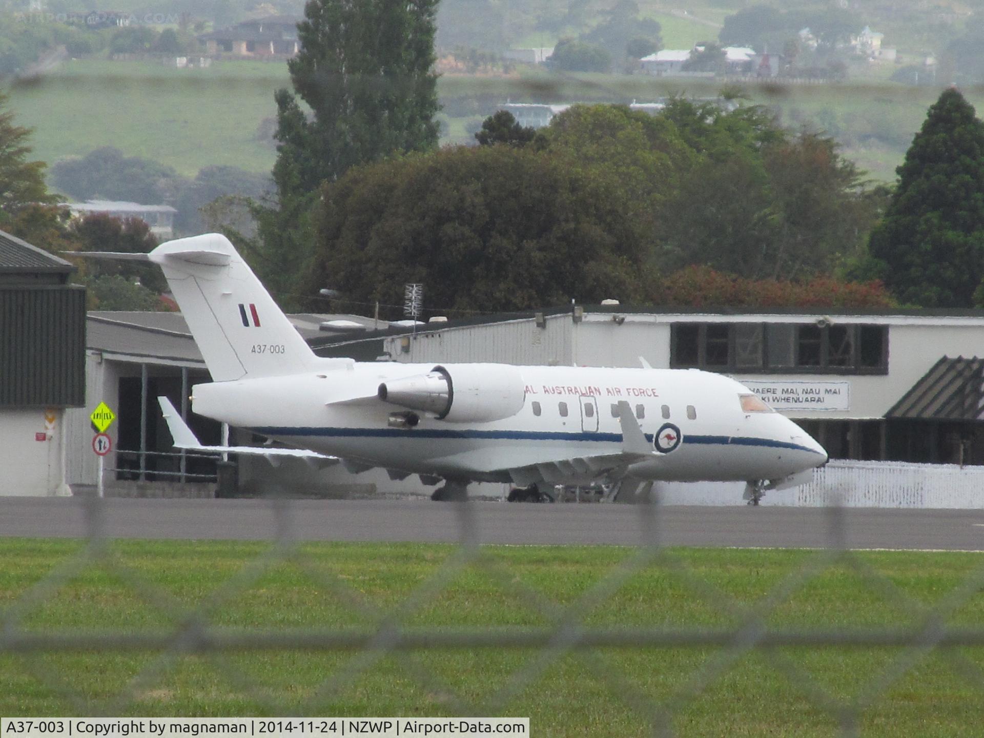 A37-003, 2002 Bombardier Challenger 604 (CL-600-2B16) C/N 5538, Shot over perimeter outer and inner fence to apron. Shame no clearer or closer vantage points at this airfield.