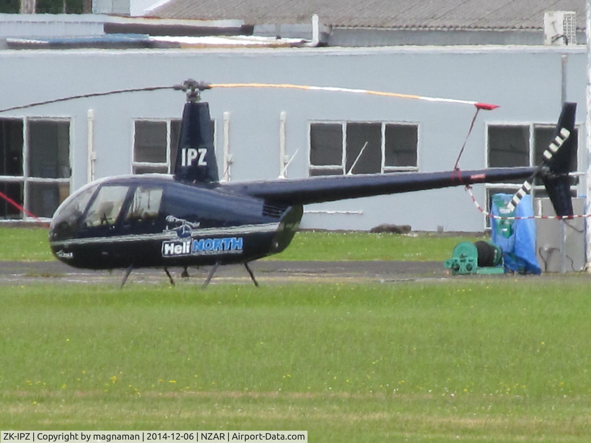 ZK-IPZ, 2007 Robinson R44 II C/N 11803, long shot across runway from cafe