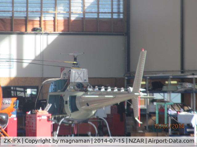 ZK-IFX, Eurocopter AS-350BA Ecureuil C/N 2190, IN oceania hangar. Now has a nice dark pink cowling with reg on it.