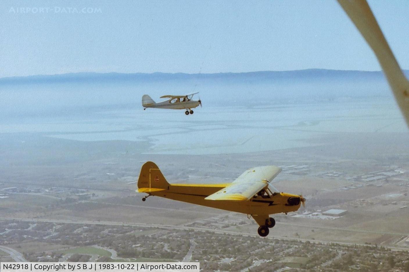 N42918, 1945 Piper J3C-65 Cub C/N 15254, Another picture of 918 & 93E over Fremont,Ca. in the SF Bay Area flying north on this beautiful day. Interesting to see the two most popular 65hp rag wing planes ever built.View is to the West with NUQ across the bay.