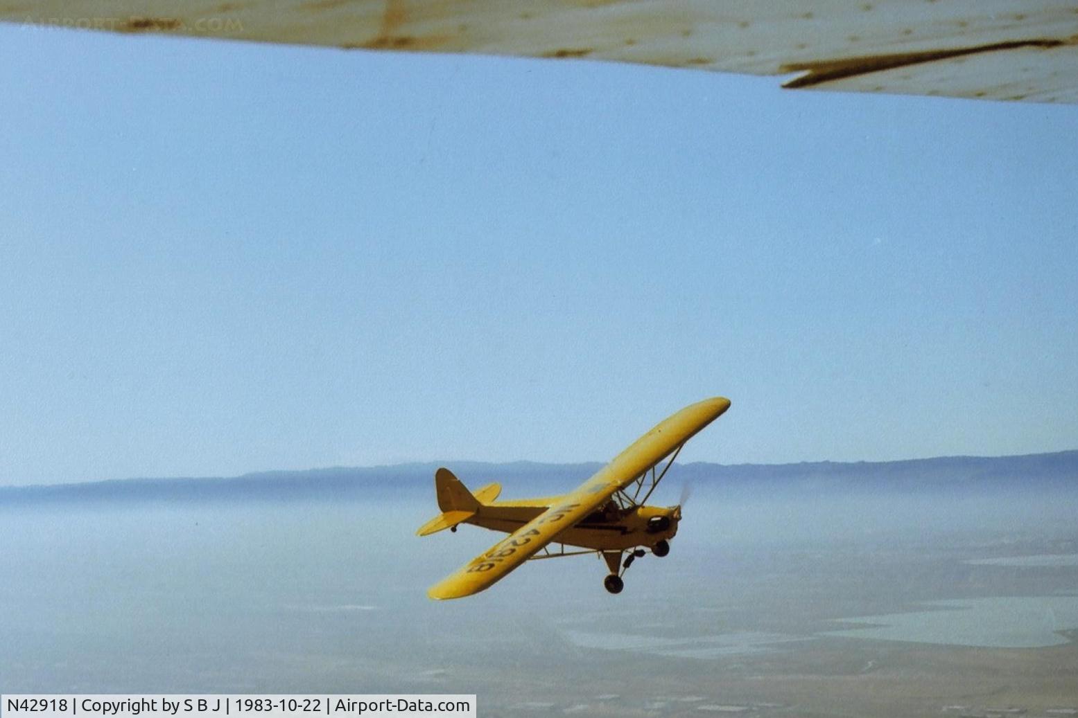 N42918, 1945 Piper J3C-65 Cub C/N 15254, With a tricky maneuver and superior flying,918 was able to get on my tail! Fortunately for me, this was not WWI or WWII. View is to the SW and not far from SJC. Fremont airport seen at very bottom of picture on the right side.