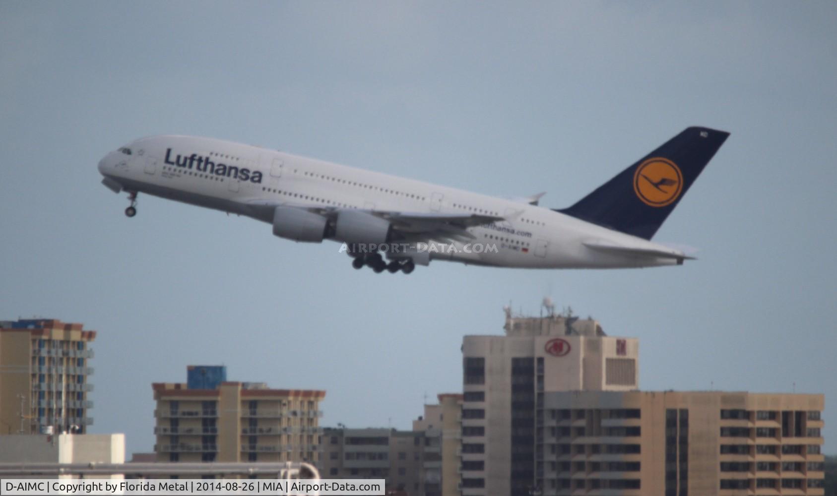 D-AIMC, 2010 Airbus A380-841 C/N 044, Lufthansa A380 departing in front of the Miami Airport Hilton