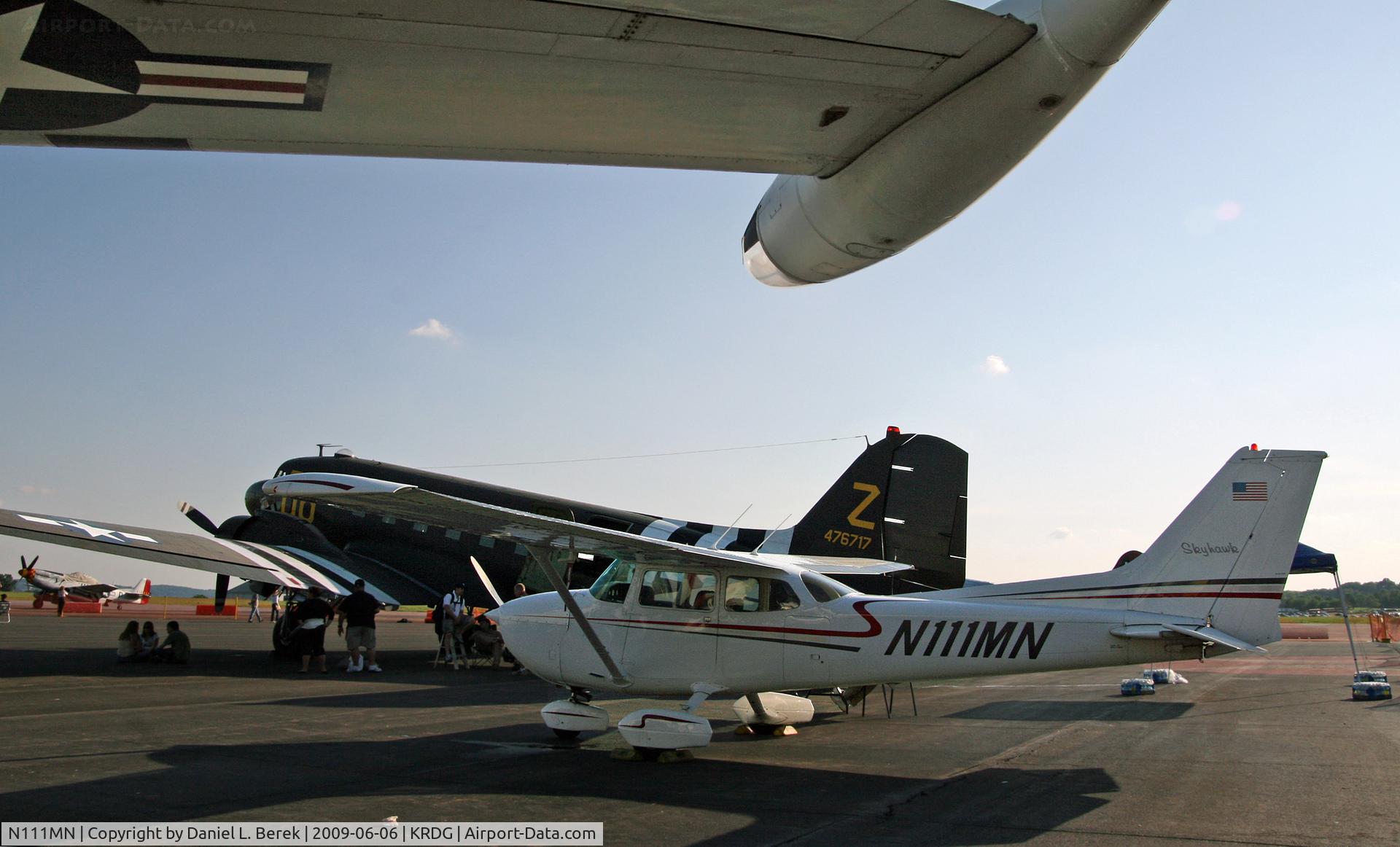 N111MN, 1976 Cessna 172N C/N 17268233, A Skyhawk is framed by two warbirds during the 2009 MAAM World War II Weekend.