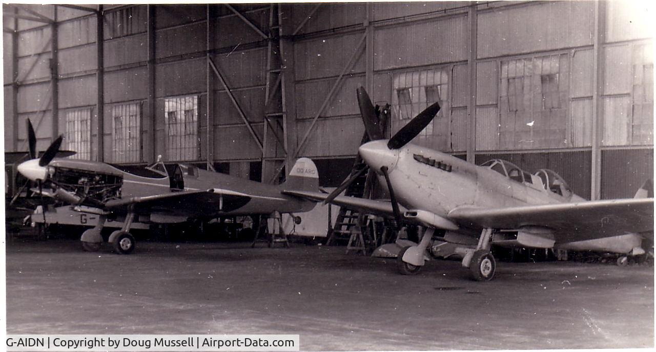G-AIDN, 1944 Supermarine 502 Spitfire TR.8 (LF.VIIIc) C/N 6S/729058, Hampshire Aero Club Hangar, early 1960's. Photo shows the clubs Spitfire G-AIDN and a visiting Belgian registered Spitfire undergoing maintenance