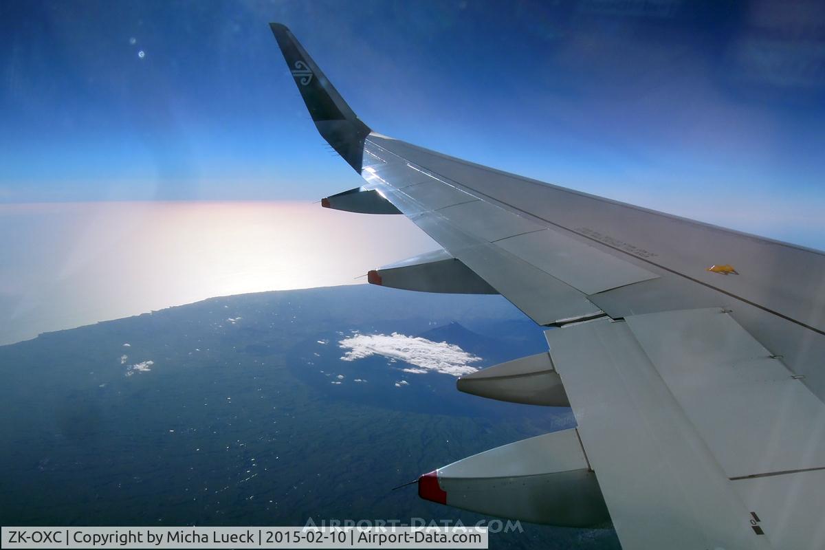 ZK-OXC, 2013 Airbus A320-232 C/N 5847, The perfectly cone-shaped Mt Taranaki appearing under the wing (CHC-AKL).
