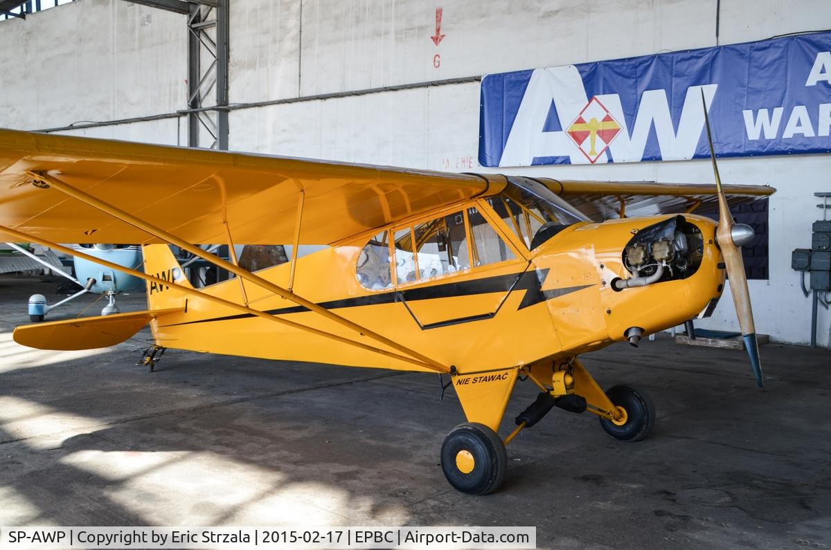 SP-AWP, Piper L-4B Grasshopper C/N 10123, SP-AWP in aan aircraft hangar, that belongs to Warsaw Aeroclub.