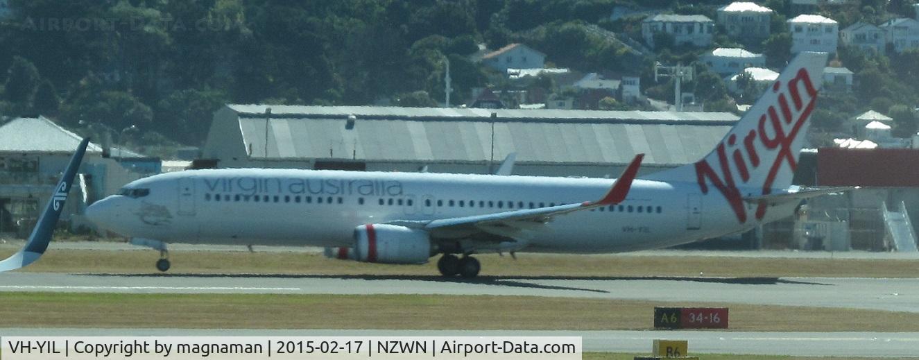 VH-YIL, 2012 Boeing 738-8FE C/N 38713, on take off from a hot wellington. Taken from terminal through glass.